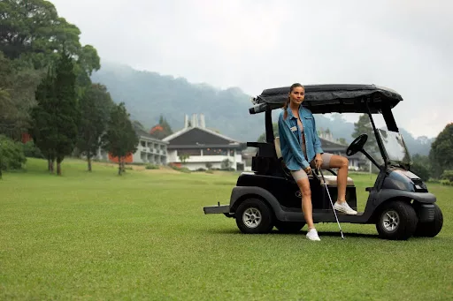 Woman with luxury golf cart